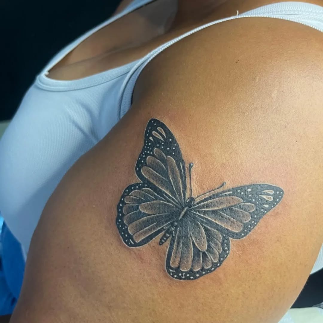 Butterfly tattoo on an upper arm by Ink Slave