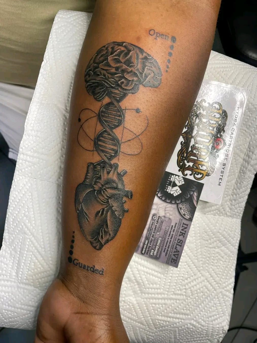 Brain, DNA and heart forearm tattoo