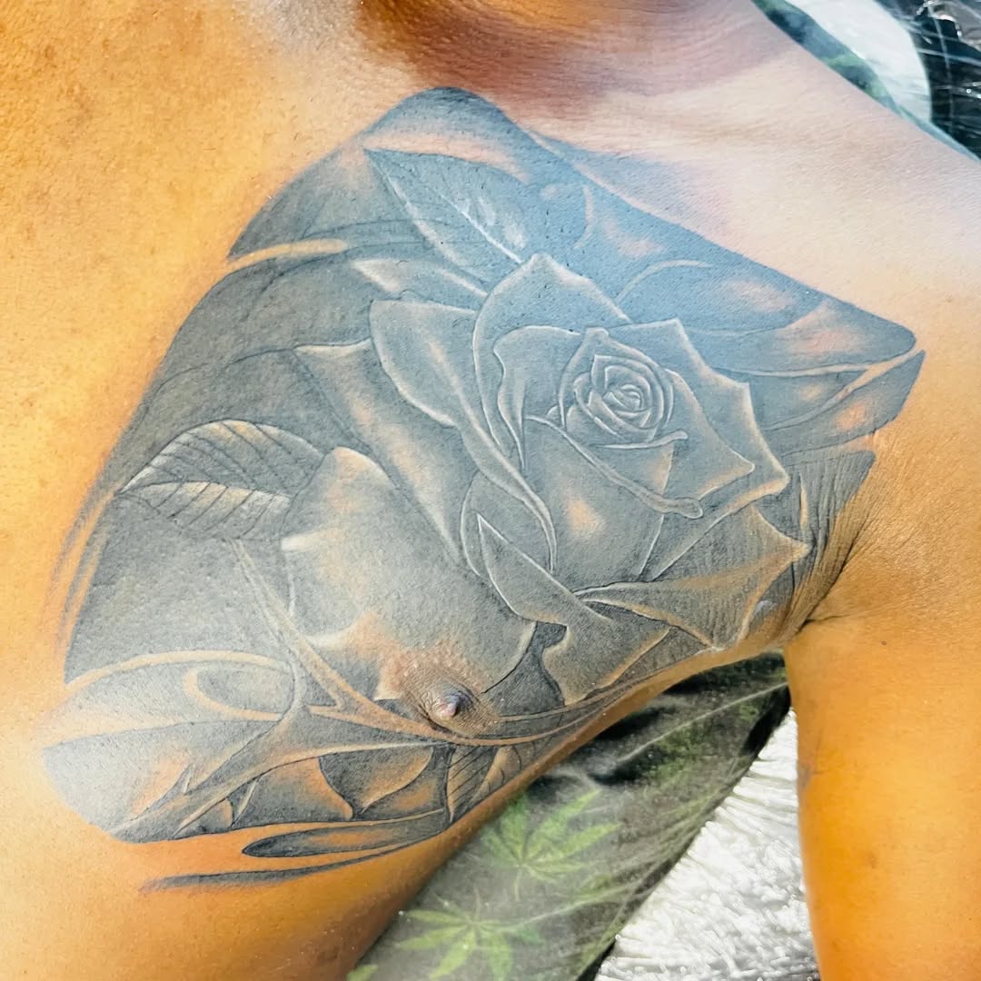 After: rose cover-up by Ink Slave covering the client's unwanted lion chest tattoo